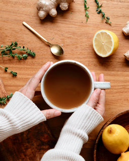 a flat lay image of a mug of bone broth made with beef bone broth concentrate native herbs